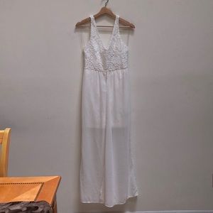 White dress with a middle slit skirt.